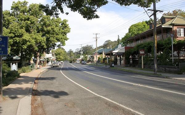 Moss Vale Road and its footpath through Kangaroo Valley village